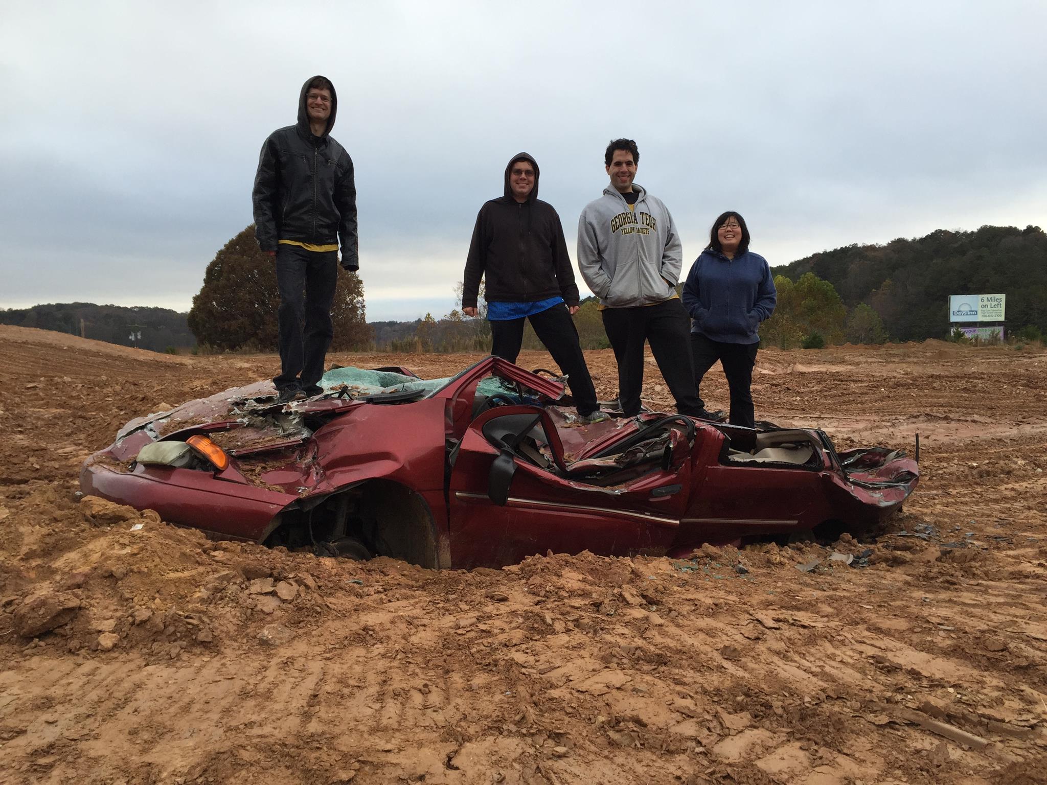 Picture of So-Mi and friends standing ontop of a van crushed by a tank.